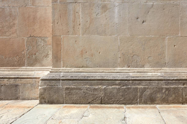 istock Stone wall with molding and floor background in sunlight, nobody 1162589941