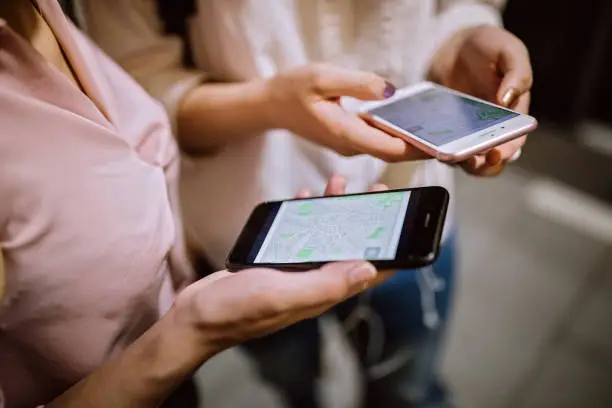 Photo of Young girls using phone on their way to school