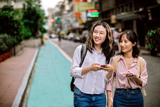 istock Young girls using phone on their way to school 1162591491
