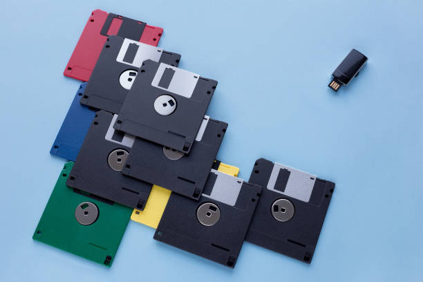 istock The evolution of digital data storage device. Floppy disks vs small flash drive. Isolated on a blue background. 1162592581
