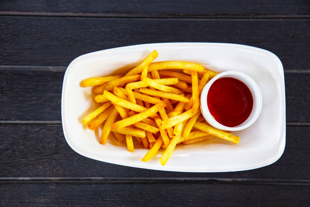 istock French fries with ketchup on wood table 1162592657
