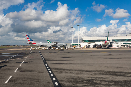 The airfield of the Rome-Fiumicino International Airport, Italy, is captured on a cloudy autumn day. Rome-Fiumicino International Airport \