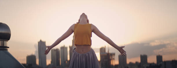 istock Young woman on a rooftop. Enjoying freedom 1162594399