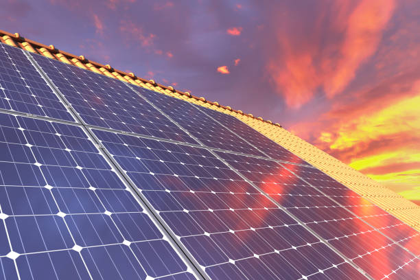 istock Solar panels modules on house roof with sunset sky in background 1162595095