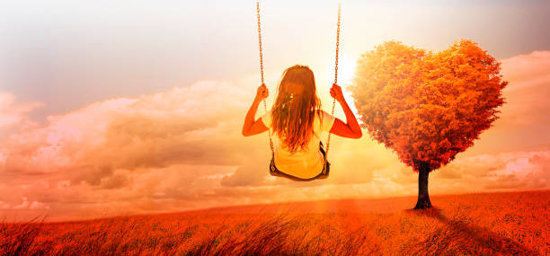 istock Woman swinging in a surreal landscape 1162595311