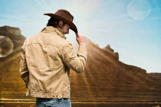 Handsome cowboy wearing denim jacket and jeans and cowboy hat