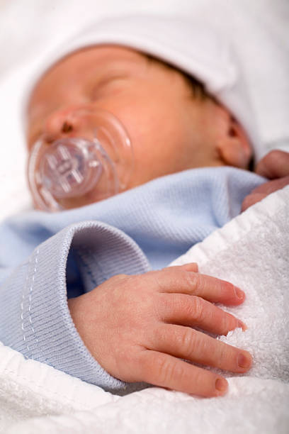 istock sleeping newborn baby with a pacifier in his mouth 116259778