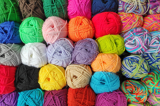 Close-up on a stack of colorful wool balls.