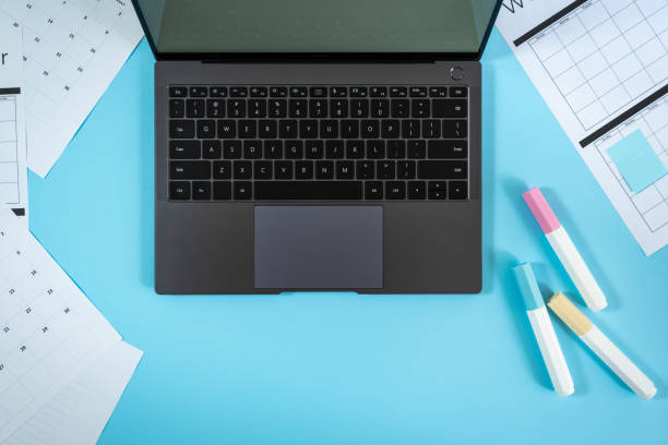 istock Laptop, stationery and planner on blue pastel background 1162601462
