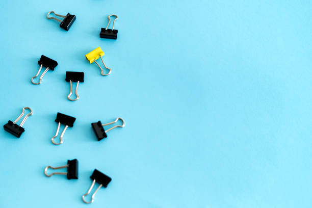 istock Black and yellow stationery clip on blue pastel background 1162601598