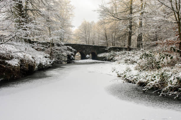 istock Minnowburn bridge, Belfast, with frozen river covered in snow 1162602450