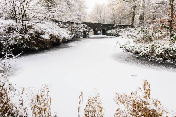 istock Minnowburn bridge, Belfast, with frozen river covered in snow 1162602470