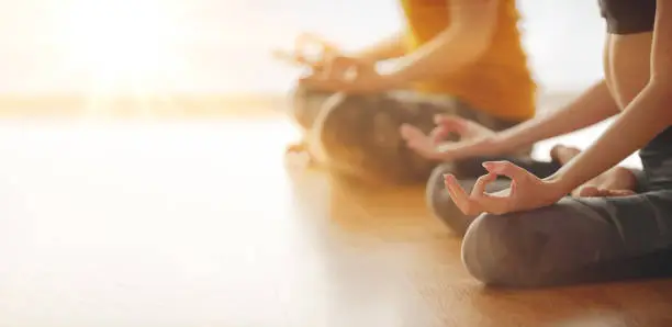 Photo of Two woman doing yoga flow in studio