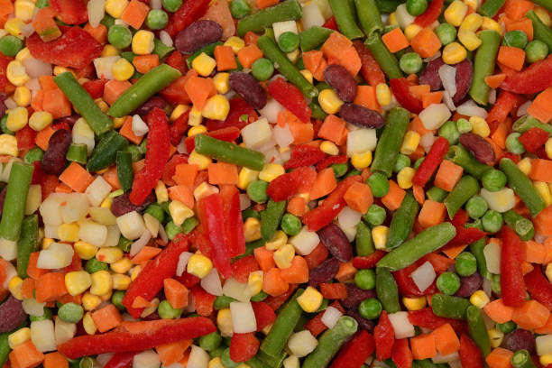 istock Sliced vegetables, corn, beans, peas, carrots, sweet peppers background. 1162607310