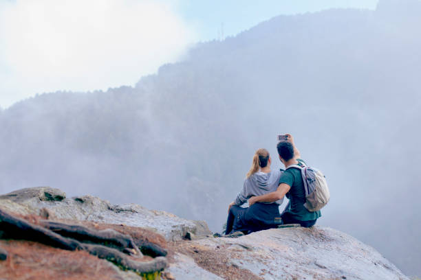 istock Couple sitting on a rock after doing trekking 1162608211