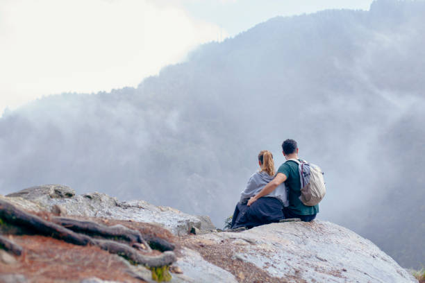 istock Couple sitting on a rock after doing trekking 1162608234