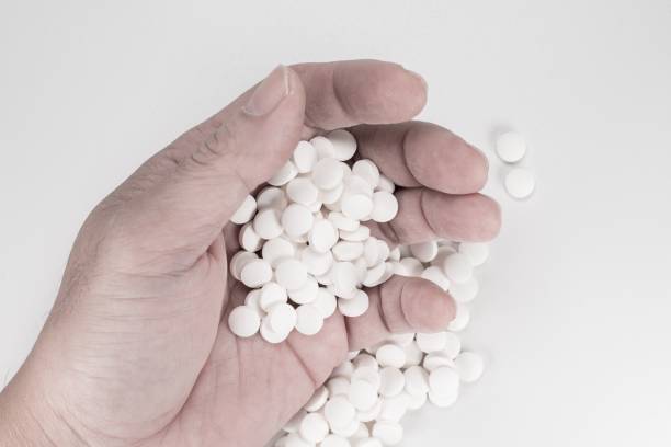 istock Suicide Pills,  Pills, tablets in dead man's hand by overdosing on medication. 1162610601