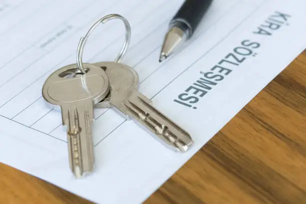 Turkish lease agreement form with pen and keys on it. Rental agreement and real estate concept.