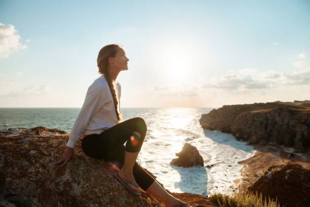 istock Girl on the sea coast 1162611996