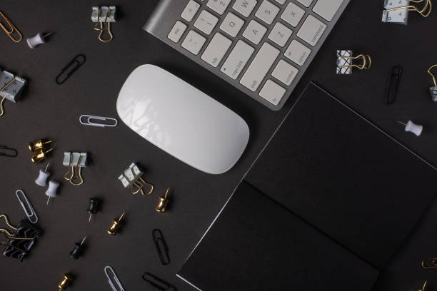 istock Layout with a black notebook blank for an inscription or design, with a pc keyboard, and a mouse. Business, work. Black style. Mockup 1162613234