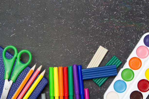 istock School and office supplies on a blackboard. Stationery. 1162614598