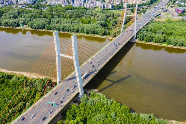 istock Aerial shooting from flying drone car traffic on modern highway bridge over river 1162614860