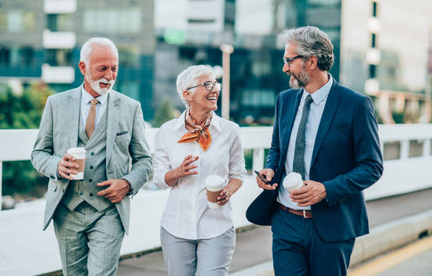 istock Three mature business people walking outdoors 1162615024