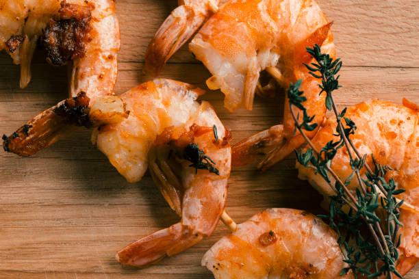istock Five headless friend shrimps with thyme sprig on them 1162615582