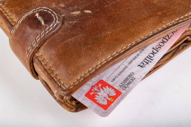 istock Leather wallet and ID card on a white table. Personal documents in leather cover. Light background. 1162615934