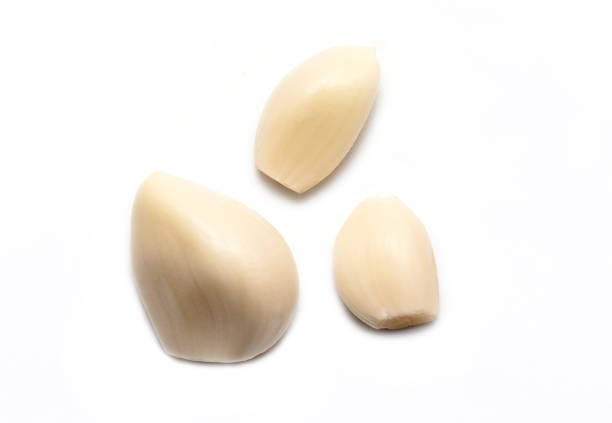 Top View of peeled Garlic isolated on white Background Top View of peeled Garlic isolated on white Background acrid taste stock pictures, royalty-free photos & images