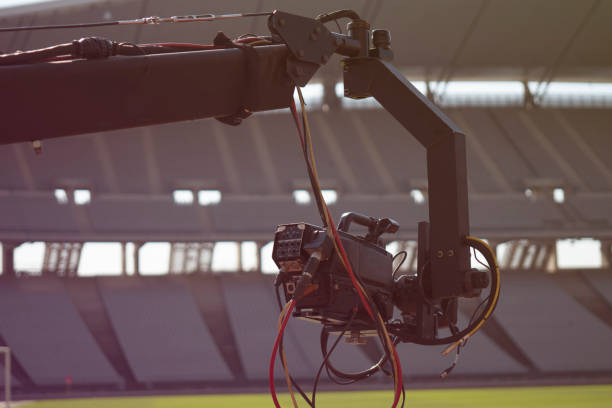 Event video camera on crane live football mach or concert. USA, Sport, Home Video Camera, Industry, Television Industry jib stock pictures, royalty-free photos & images