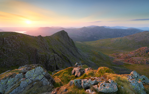 Sunset over Ennerdale Water from Scoat Fell with views of Steeple In the English Lake District, UK.