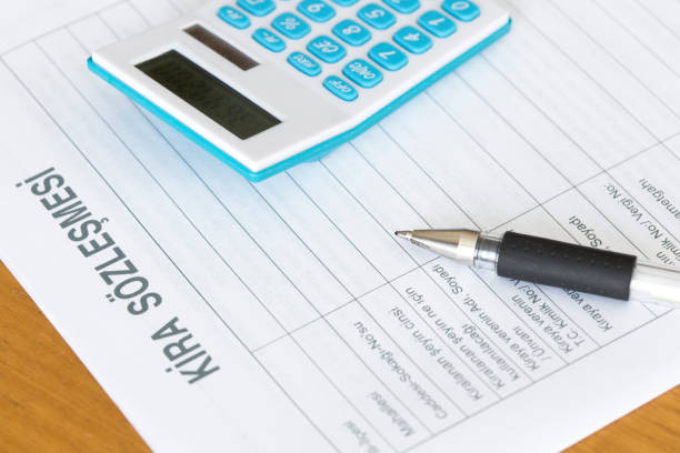 Rental agreement form with calculator and pen. Real estate concept.