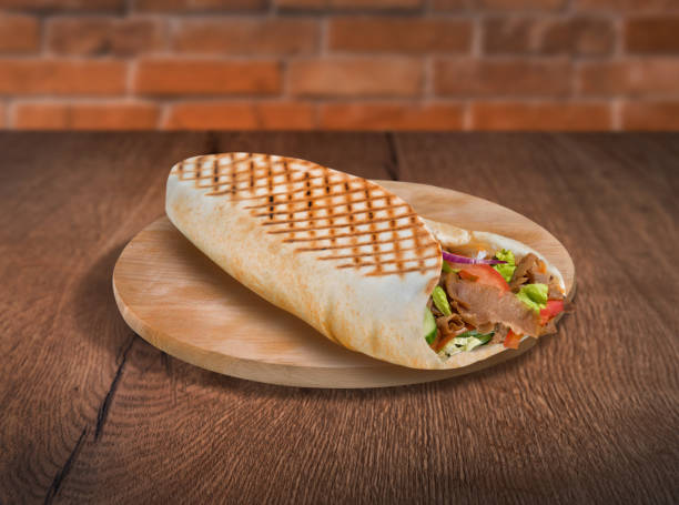 istock Pita wrap sandwich on wooden background 1162619570