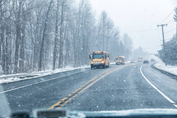 istock Blizzard Snow School Buses Approaching on Suburban Highway 1162619604