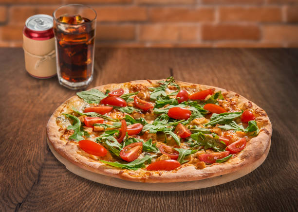 Pizza and cola on wooden background. Selective focus. For fast food restaurant design or fast food menu