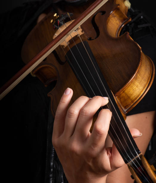 istock Woman playing the violin showing hands holding the bow 1162620343