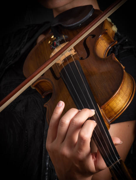 istock Woman playing the violin showing hands holding the bow 1162620344