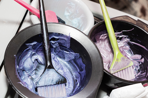 Hair dye in bowls and brush for hair coloring