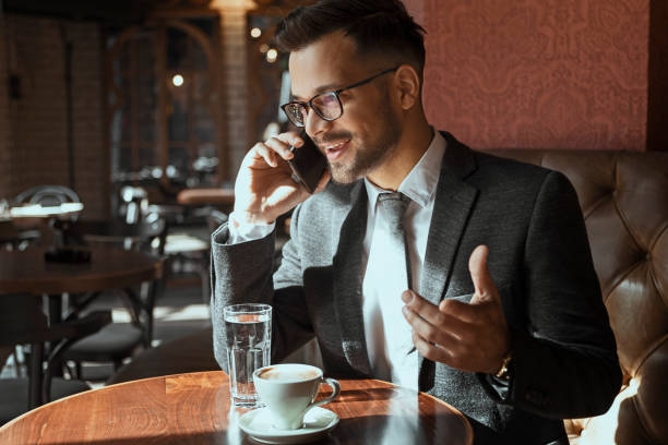 istock Businessman on a coffee break using phone in cafe 1162623068
