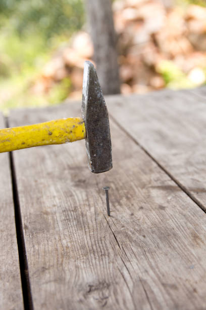 istock To hammer a nail with a hammer. 1162623120