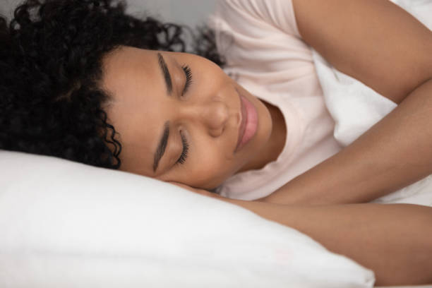istock Calm black woman sleeping well in comfortable bed, close up 1162624111