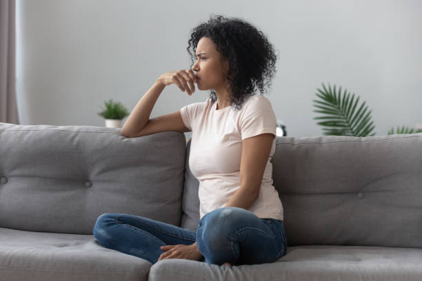 istock Sad thoughtful african girl on sofa looking away feel depressed 1162624134