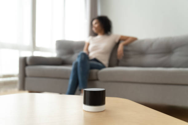 istock Portable wireless speaker on table with african woman on background 1162624164