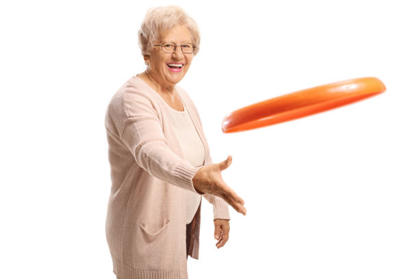 istock Cheerful elderly woman throwing a plastic disc 1162624266