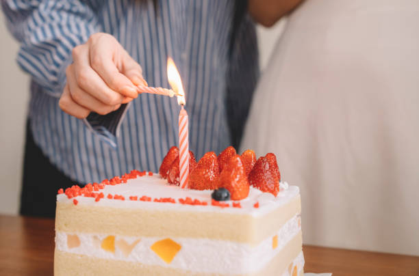 istock birthday celebration close up lighting up candle 1162624386