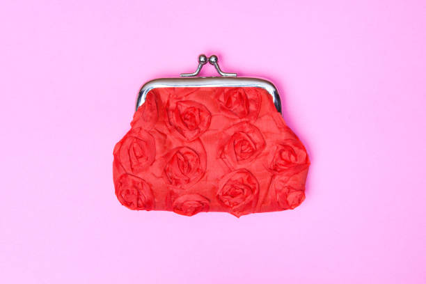 Red purse on a pink background. Red wallet for coins