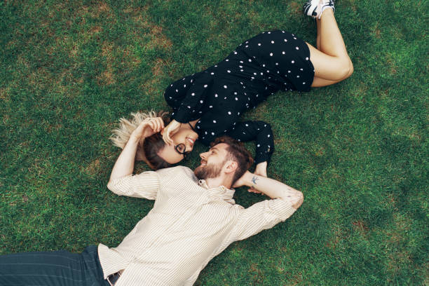 istock Couple in love lying on the grass 1162625688