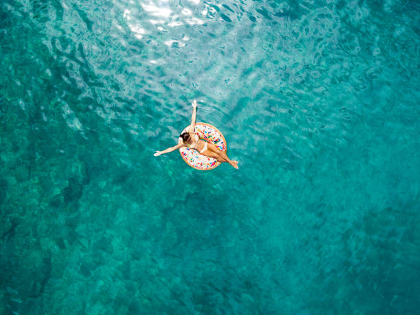 istock Woman on inflatable doughnut 1162625779