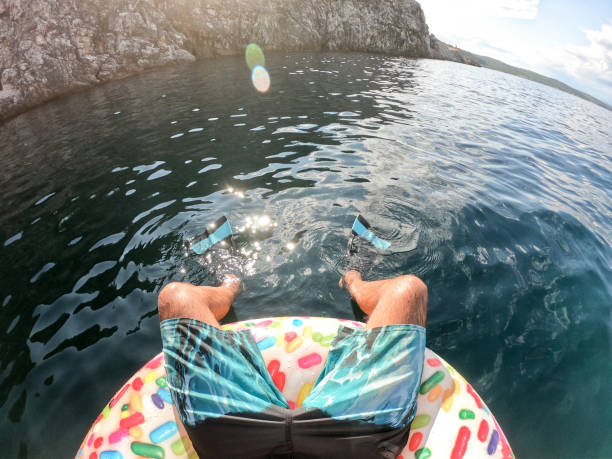 istock Man sitting on floatie in sea 1162626636